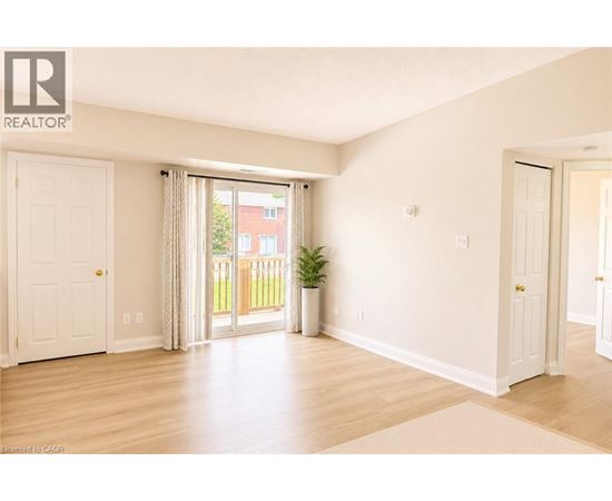 A room with a sliding glass door leading to a balcony.