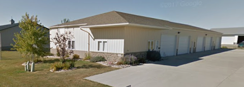 A long building with a white garage door.
