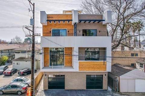 A modern two-story house with a mix of brick and wood accents.