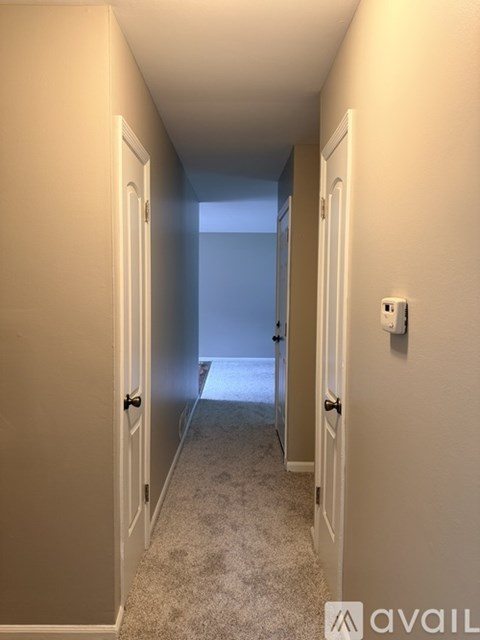 A white toilet is in a small bathroom.