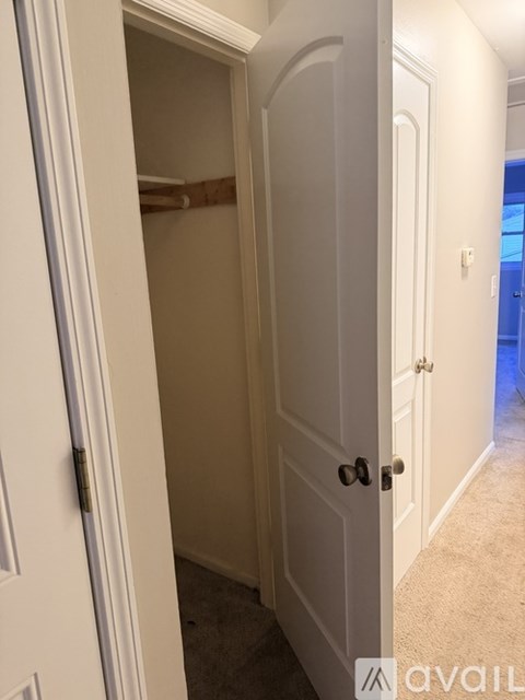 A white door is open to a hallway.