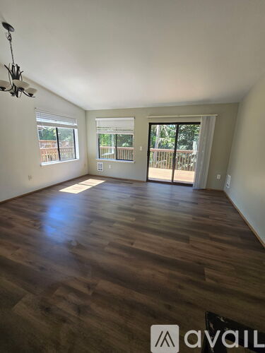 A room with wooden flooring and a ceiling fan.