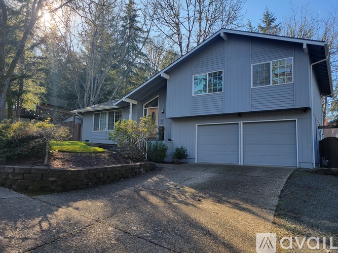 A house with a grey exterior and a white garage door.