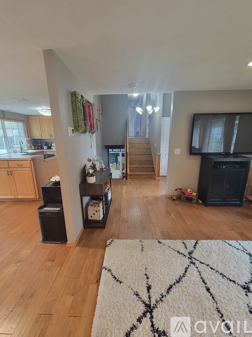 A living room with a fireplace and a rug on the floor.