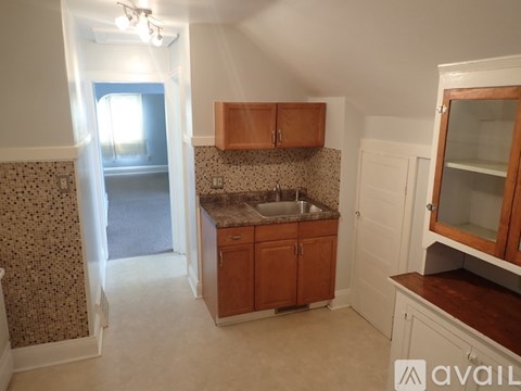 A kitchen with wooden cabinets and a granite countertop.
