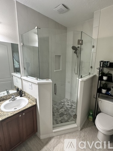A bathroom with a sink, toilet, and shower.