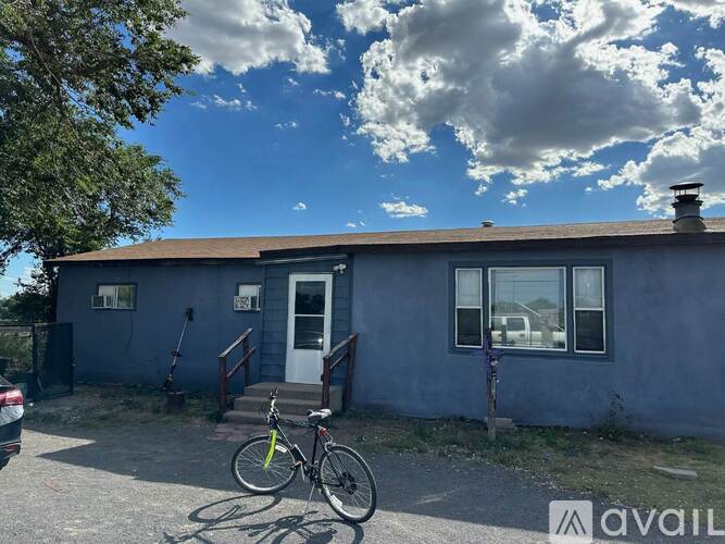 A house with a bicycle parked in front.