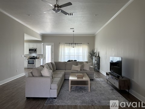 A living room with a grey couch and a coffee table.
