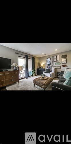 A living room with a couch, a coffee table, and a television.
