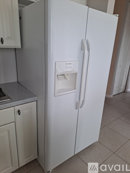 A white fridge with a sticker on it.