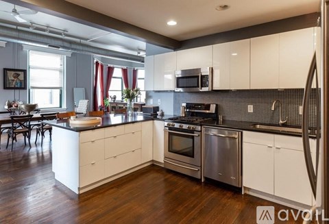 A kitchen with white cabinets and stainless steel appliances.
