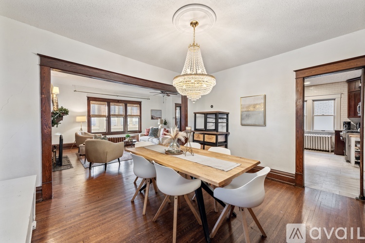 A dining room with a wooden table and chairs.