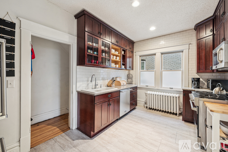 A kitchen with wooden cabinets and a white refrigerator.
