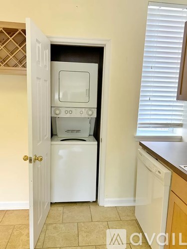 A white oven and dishwasher are built into a kitchen cabinet.