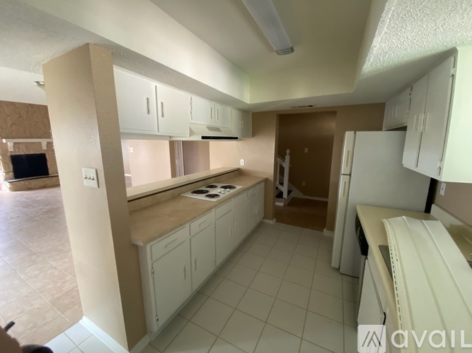 A kitchen with white cabinets and a countertop.