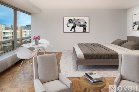 A bedroom with a large bed and a chair.