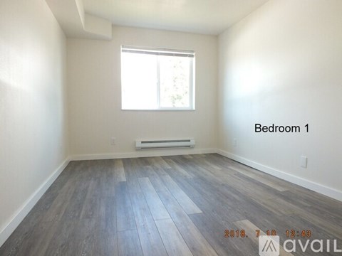 A room with a window and a wooden floor is labeled Bedroom 1.