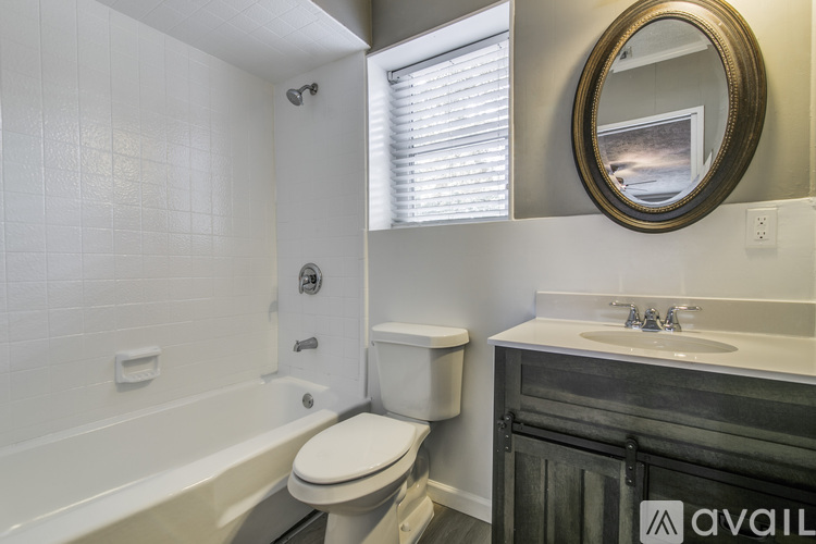 A bathroom with a toilet, sink, and tub.