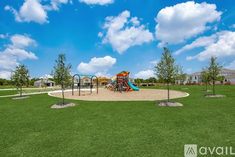 A playground with a slide and swings under a blue sky.