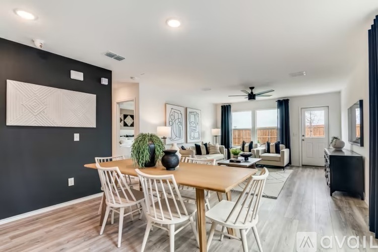 A modern dining room with a wooden table and chairs.