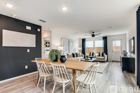 A modern dining room with a wooden table and chairs.