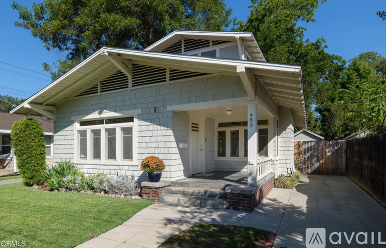 A house with a white exterior and a large front yard.