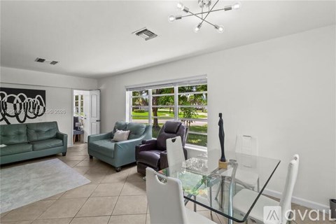 A living room with a glass table and chairs.