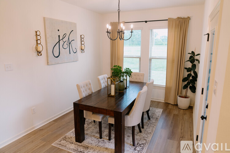 A dining room with a wooden table and chairs.