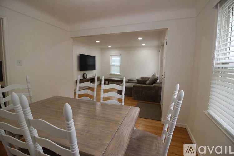 A dining room with a wooden table and chairs.