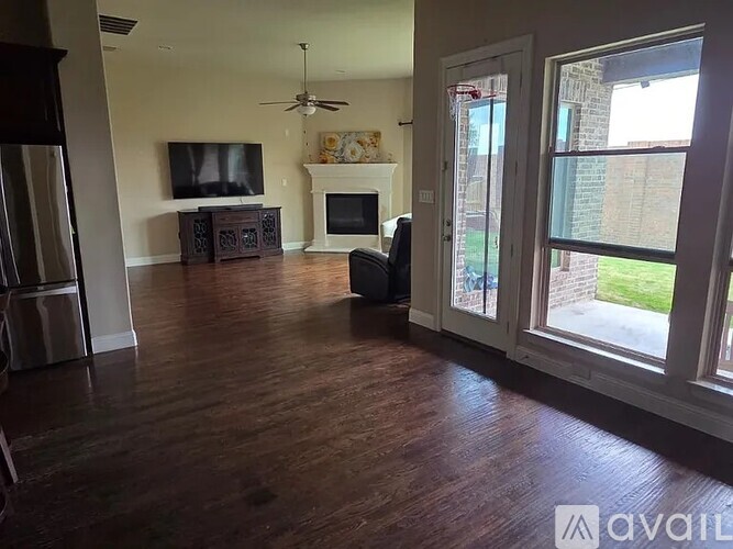 A living room with a fireplace and a television.