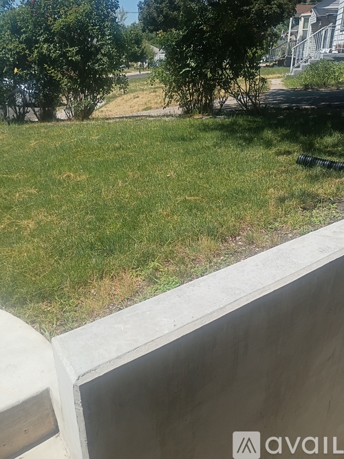 A grassy area with a house in the background.