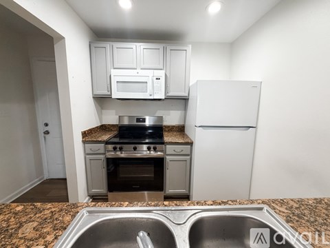 A kitchen with granite countertops and stainless steel appliances.