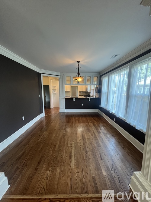 A room with wooden floors and a chandelier.