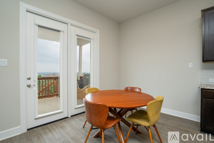 A dining room with a wooden table and chairs.