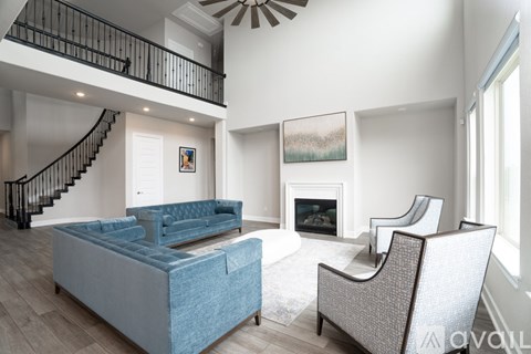 A living room with a blue couch and a fireplace.