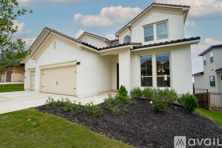 A modern house with a white exterior and a brown roof.