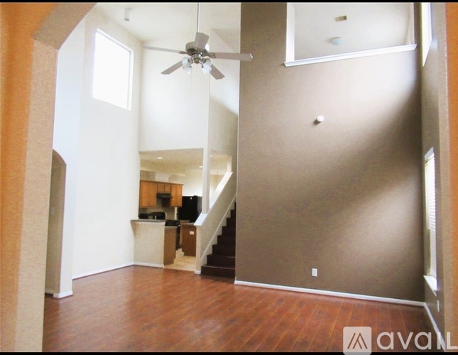 A living room with a staircase leading to the upper floor.