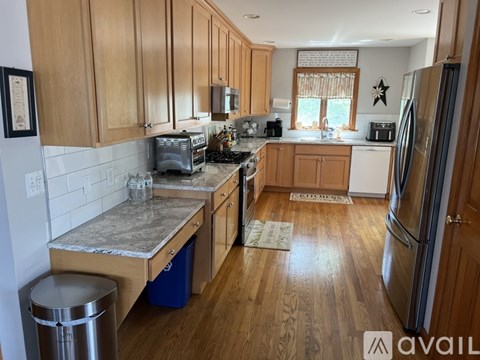 A kitchen with wooden cabinets and a granite countertop.