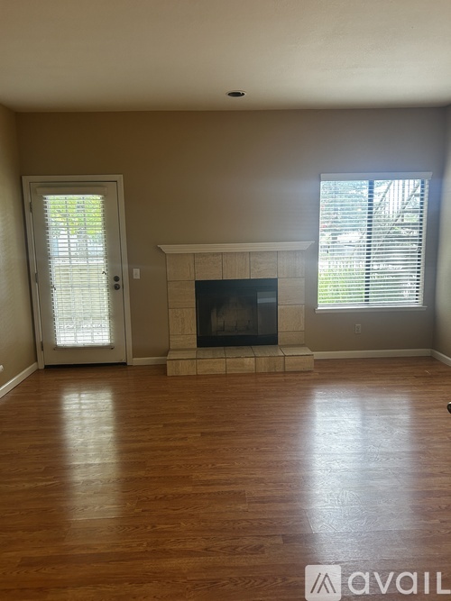 A room with a fireplace and a door leading outside.