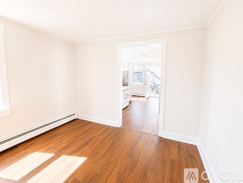 A room with wooden floors and white walls.