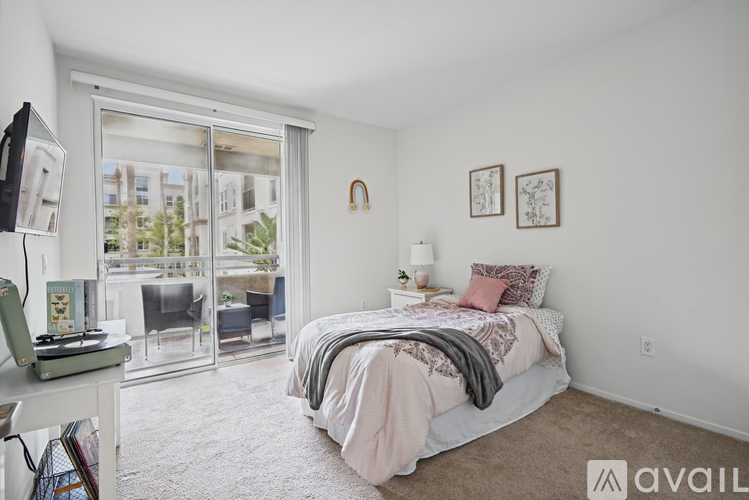 A bedroom with a large bed and a desk with a computer on it.