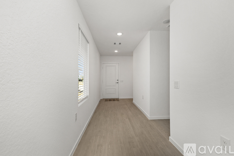 A long hallway with a door at the end.