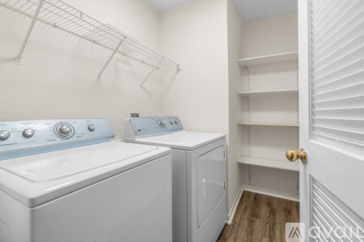 A white laundry room with a washer and dryer.