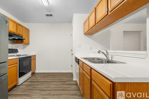 A kitchen with wooden cabinets and a white countertop.
