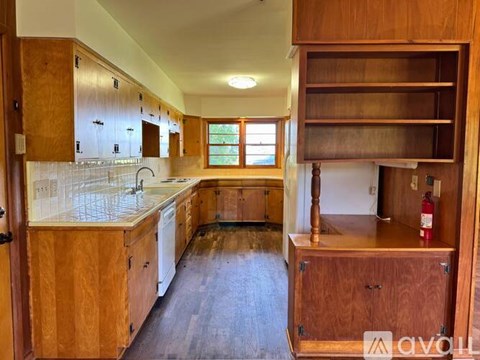 A kitchen with wooden cabinets and a white countertop.