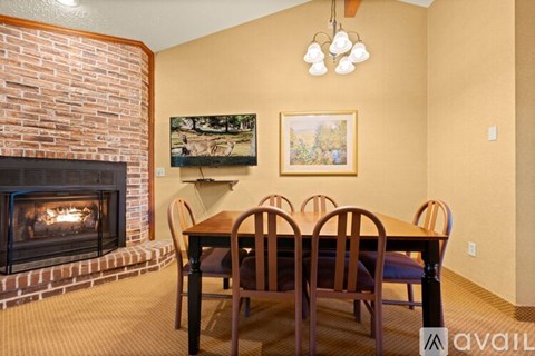 A room with a fireplace and a painting on the wall.