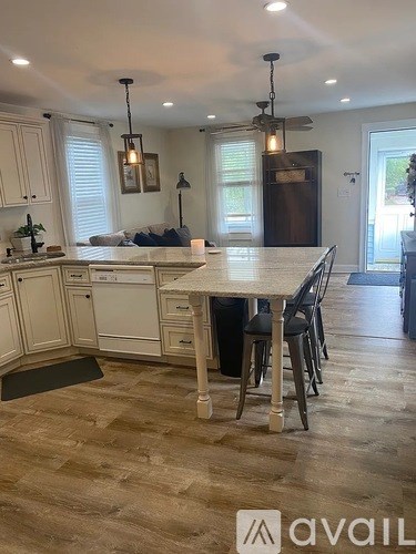 A kitchen with a table and chairs in the middle of the room.