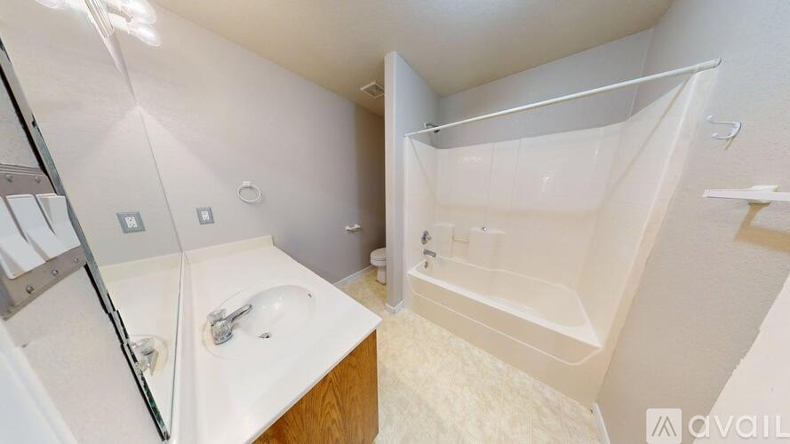 A white bathroom with a sink and a bathtub.