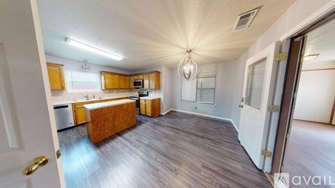 A kitchen with wooden cabinets and a white ceiling.