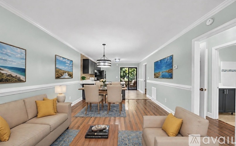 A living room with a couch, chairs, and a coffee table.